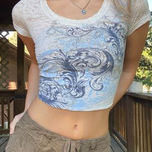 cream see-through material, graphic design on front/back, size XS from Maurice’s